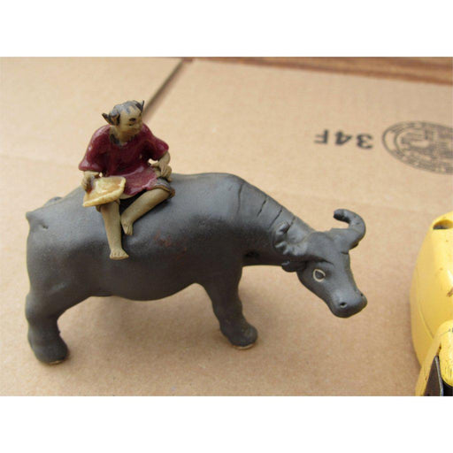 Boy On A Buffalo Ceramic Figurine