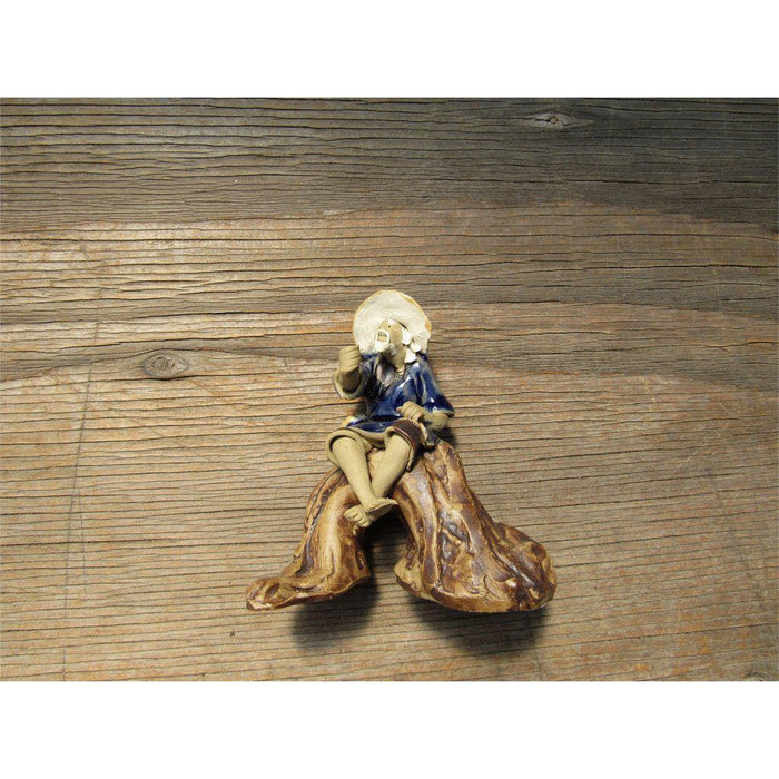 Fisherman Sitting On A Log Ceramic Figurine Front