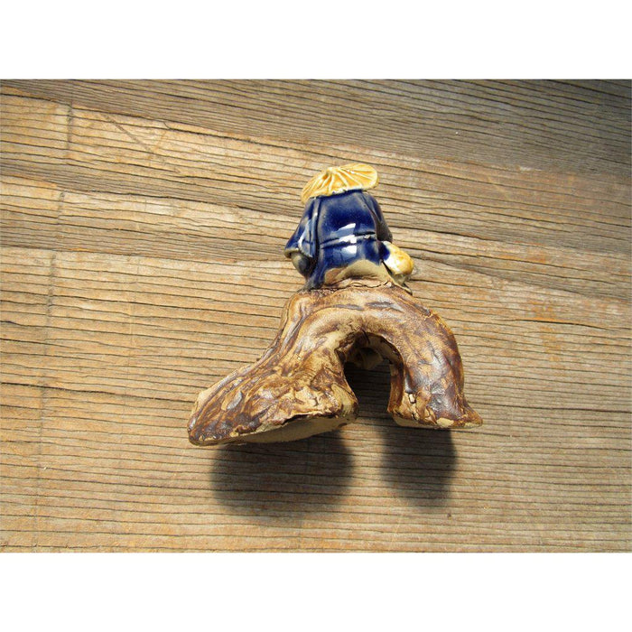 Fisherman Sitting On A Log Ceramic Figurine Back