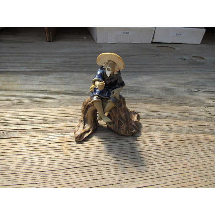 Fisherman Sitting On A Log Ceramic Figurine
