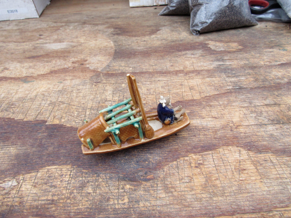 Man on a Large Sampan Boat Figurine Back