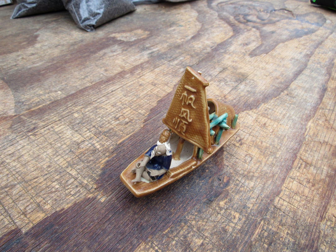 Man on a Large Sampan Boat Figurine