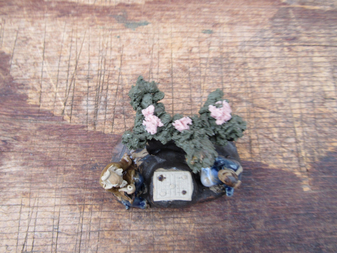 Men Playing Under Cherry Blossom Figurine Top