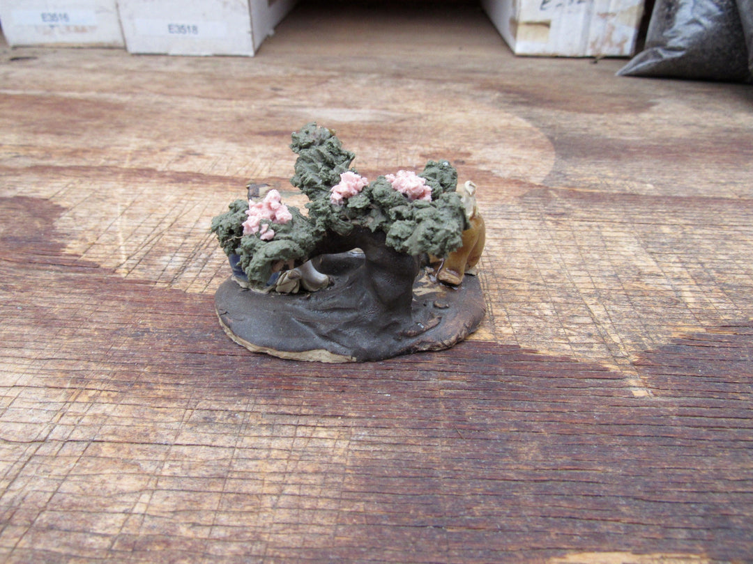 Men Playing Under Cherry Blossom Figurine Back